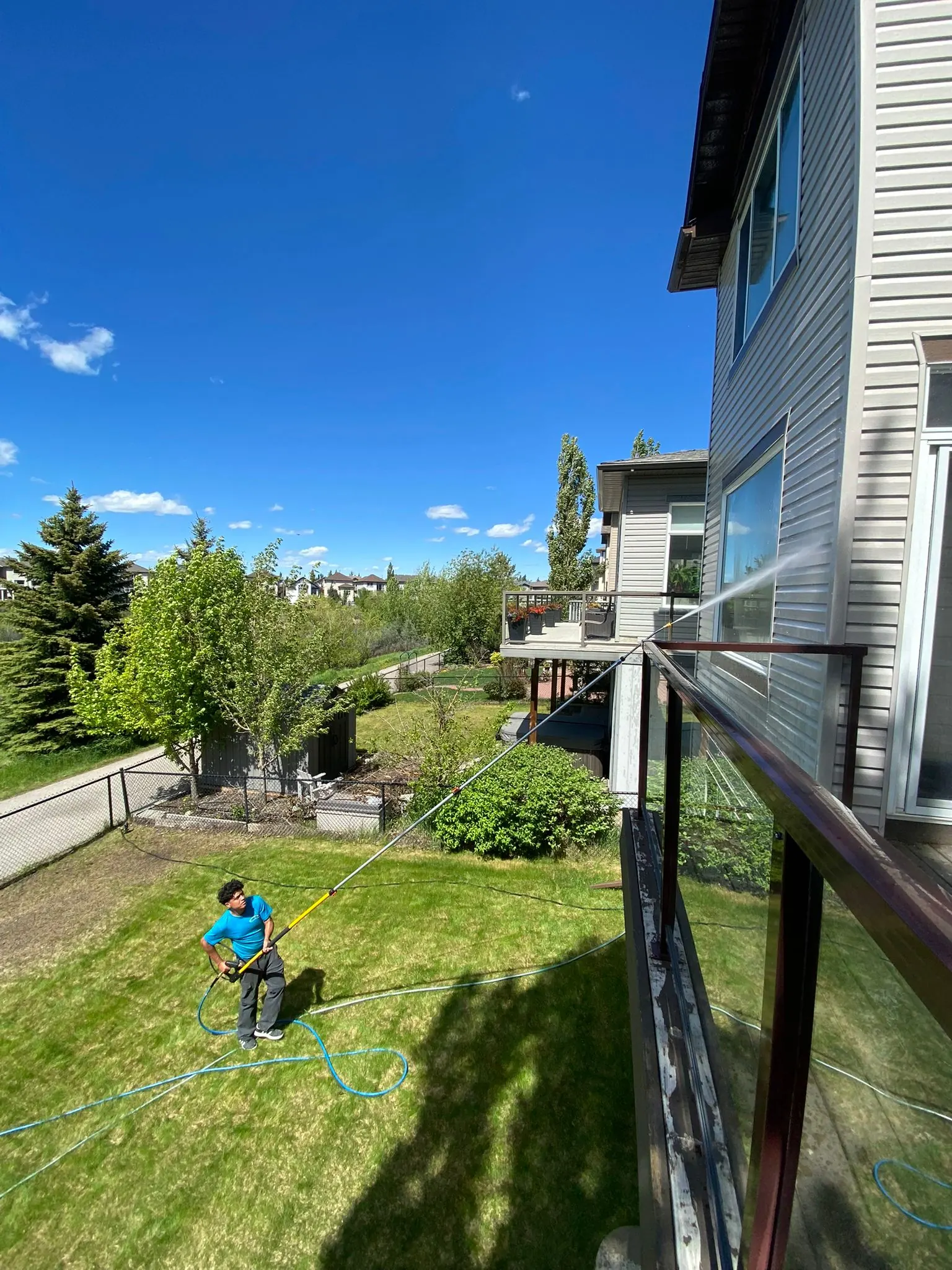 Soft washing the siding of a Calgary home