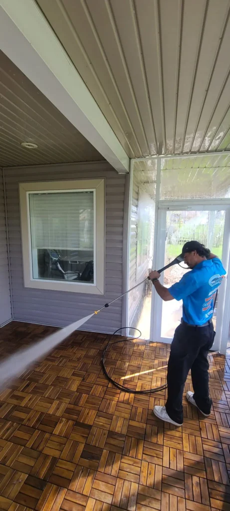 Pressure washing a deck on a Calgary home
