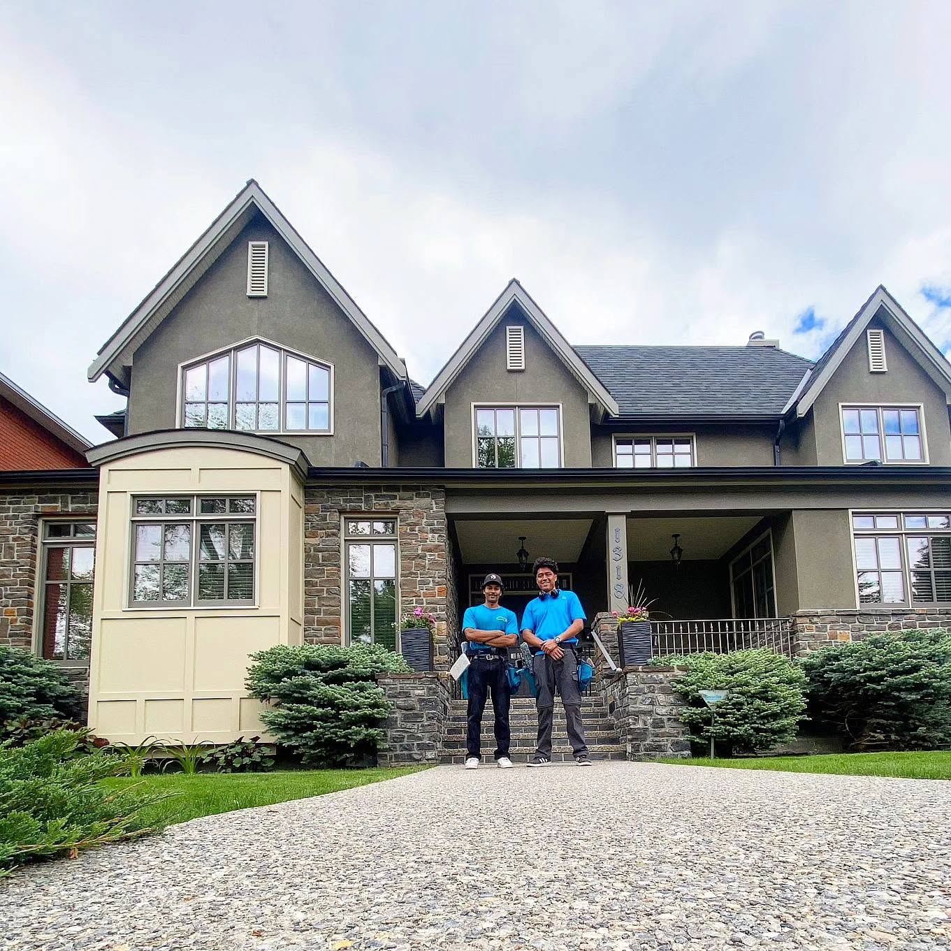 The Pro Window Cleaning Calgary team standing in front of a home they just cleaned the windows on